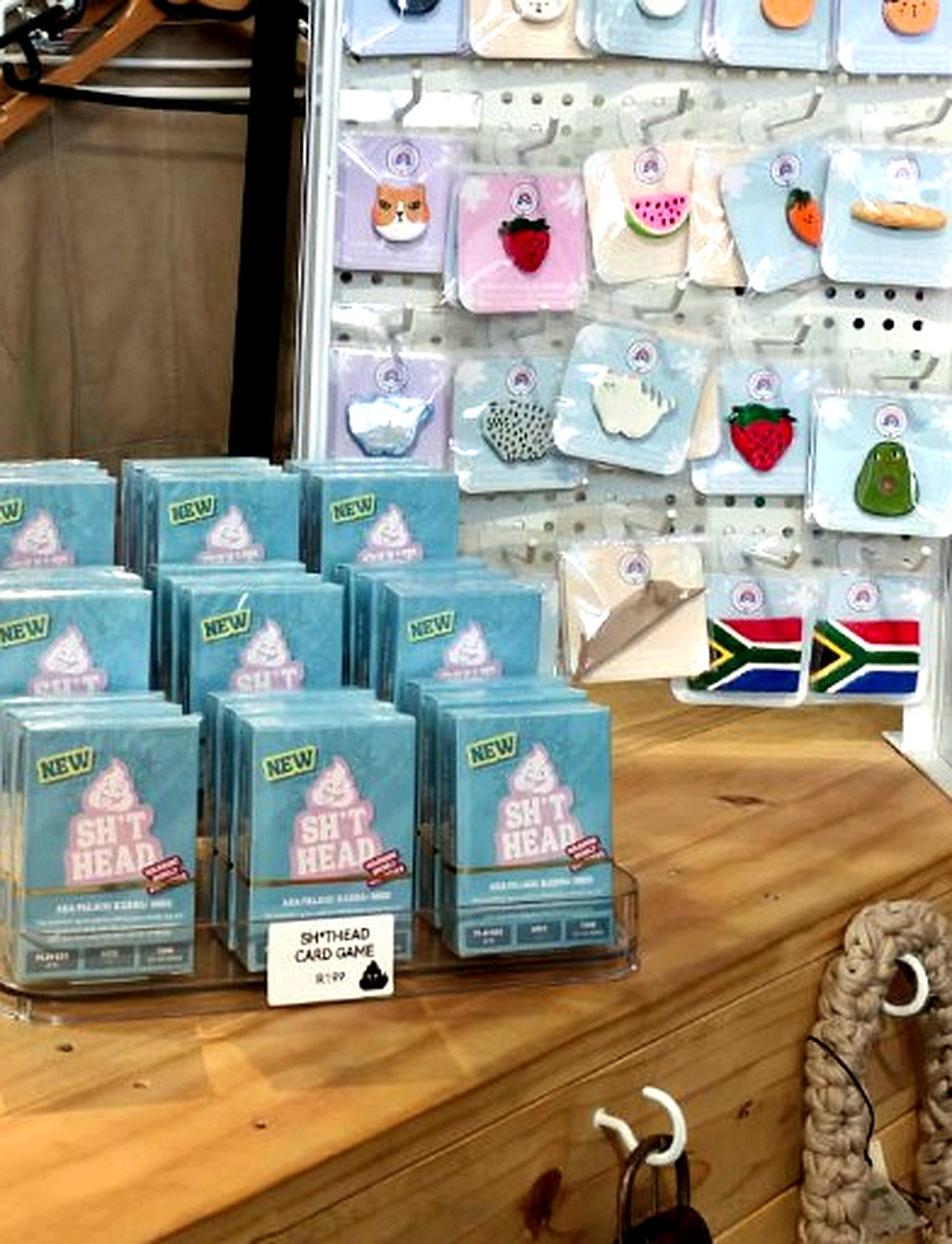 Sh*thead card game boxes on an acrylic stand at YBMV Collective retail counter, priced R199